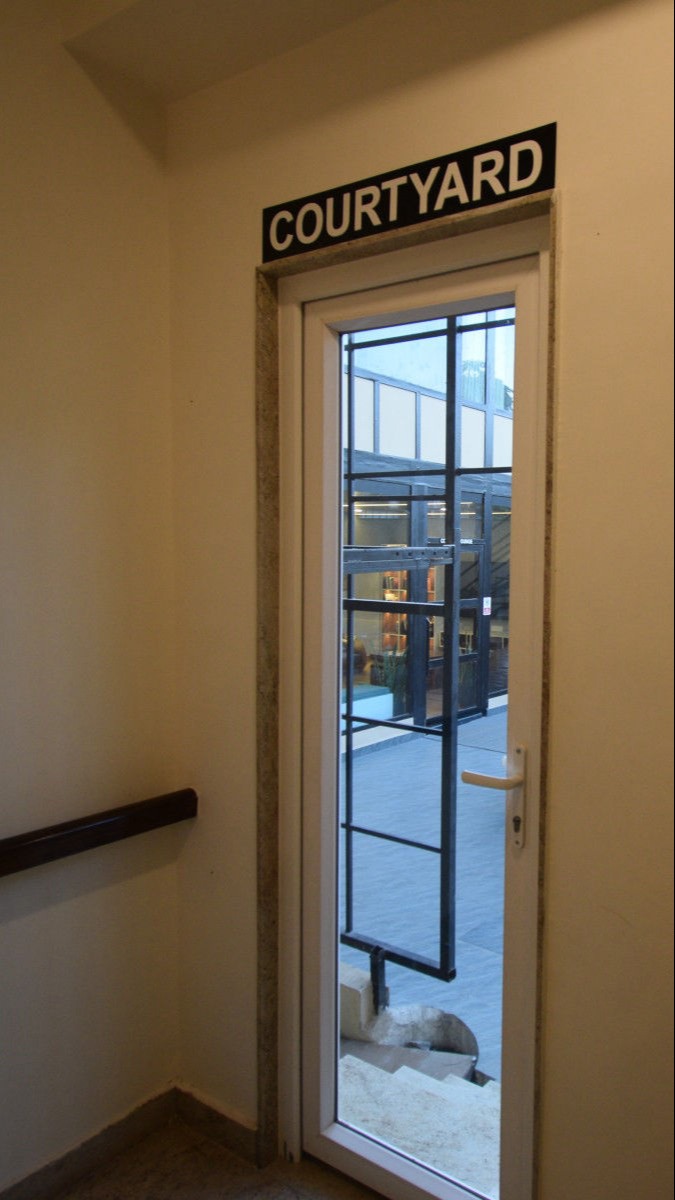 To courtyard